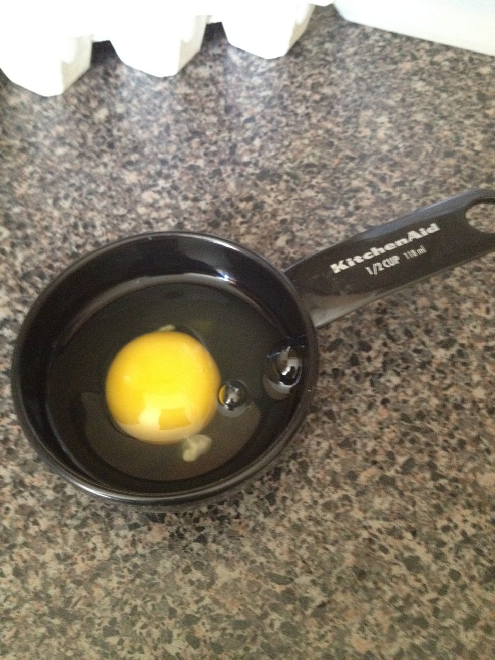 Next, crack an egg into a measuring cup or ramekin