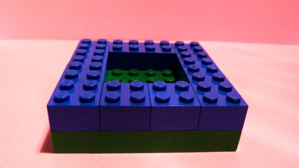 Next create a thick layer with any bricks with width of 2 and any length around the edge of base.