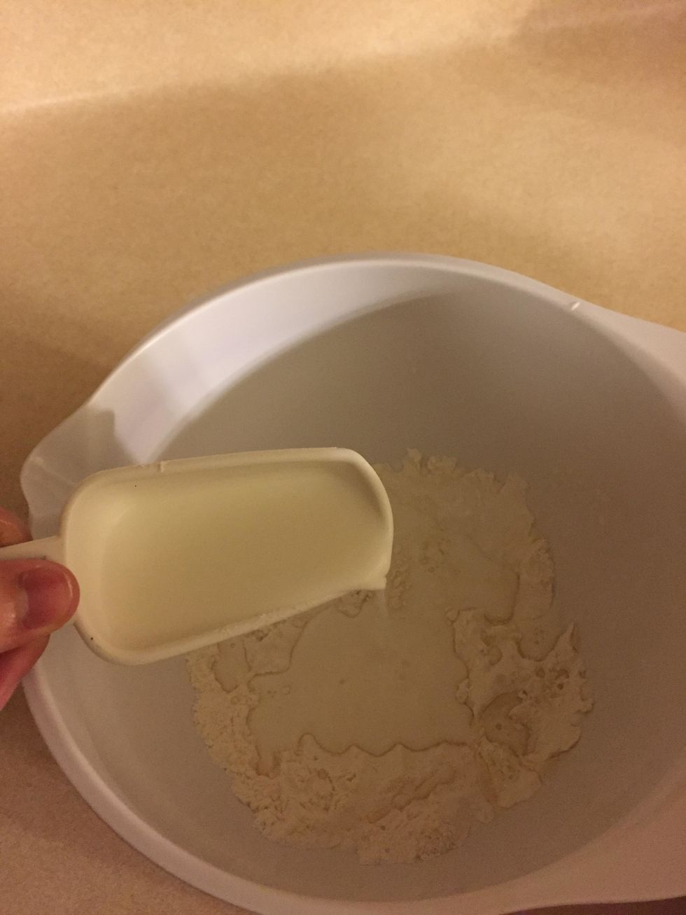 Next, create a well in the powder and pour in the milk, eggs, and melted butter. You can also add other ingredients, like vanilla extract, to add flavor.