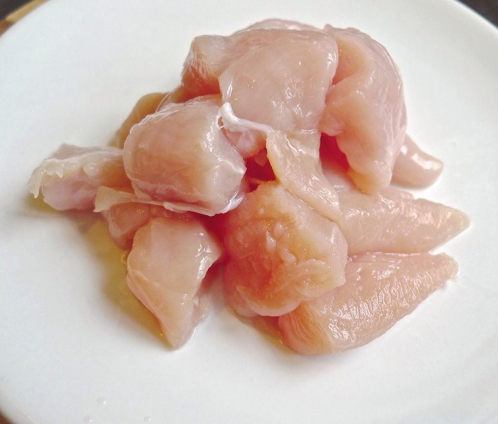 Next, cut 300g chicken thigh fillets into 1 inch cube. Season with a pinch of salt and pepper.
