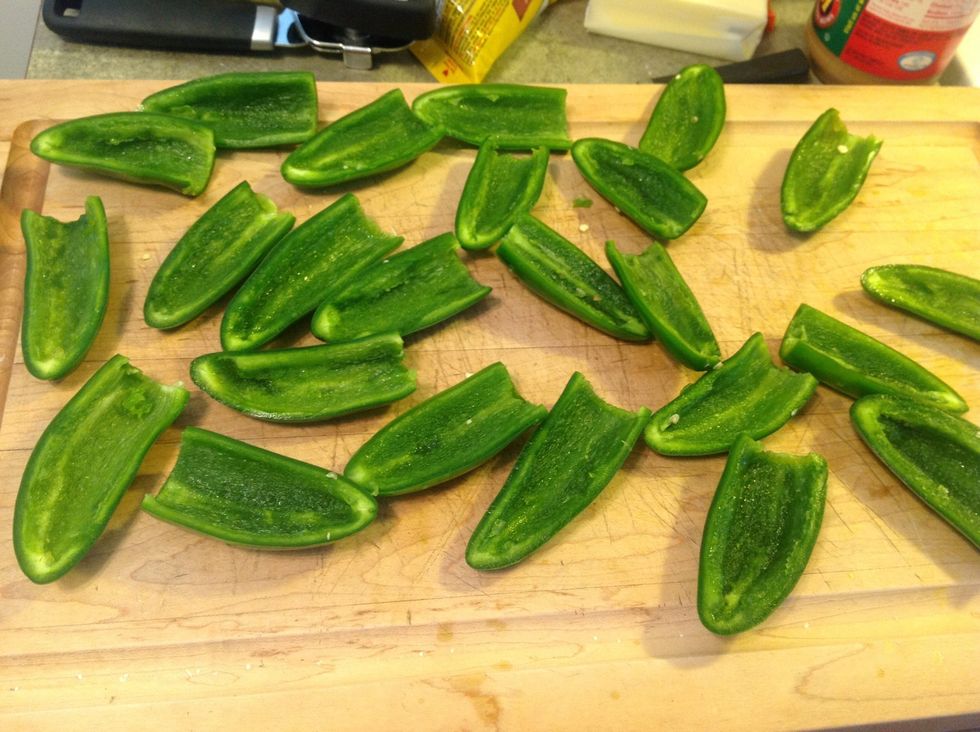 Next, cut peppers in half length-wise and then take a teaspoon to remove the seeds and veins. WEAR GLOVES!!! I actually use quart size baggies as gloves. Pepper juice and oil will burn for days.