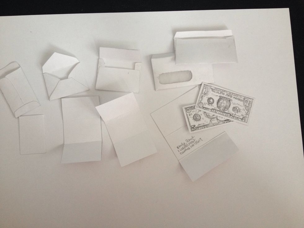 Next, cut pieces of paper or whatever you'd like to go in your envelope. I made money for one of mine, a bill, a resume paper and regular "love letter" pieces. Then, glue the flaps together carefully.