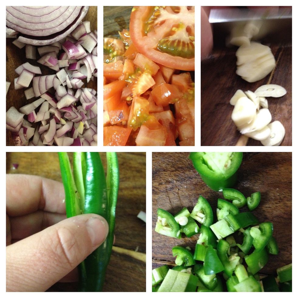 next, cut the onion, tomato, garlic, and serranos to mix in the avocados. my Tia taught me to cut a Serrano by making a cross cut at the tip, than slicing it - making four smaller pieces.