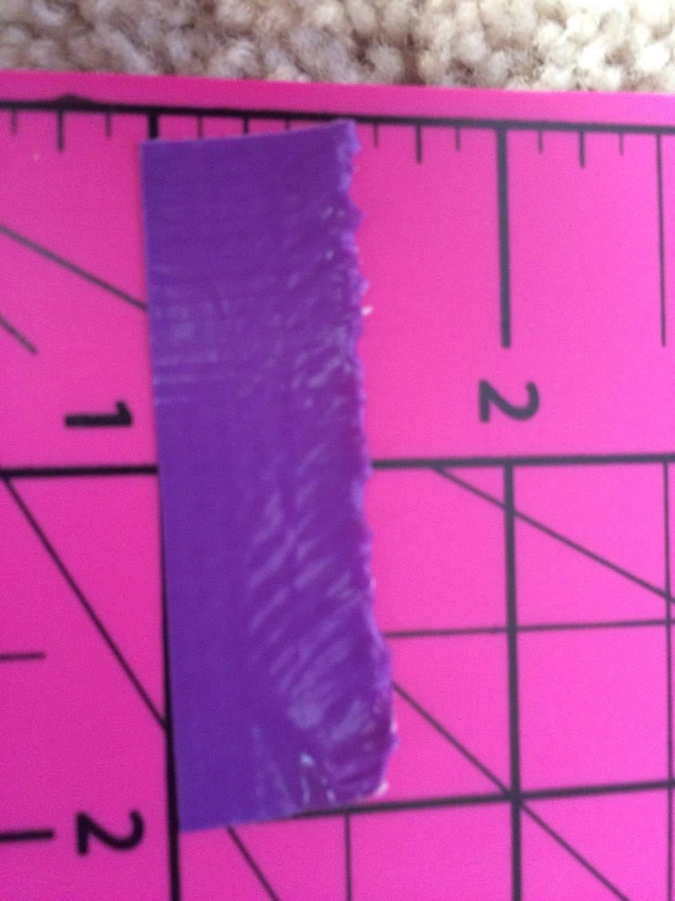 Next cut two 2 inch pieces of colored duct tape and place them on the sides of the 3 inch piece you made. Put it on the wallet and secure the bottom with colored duct tape.