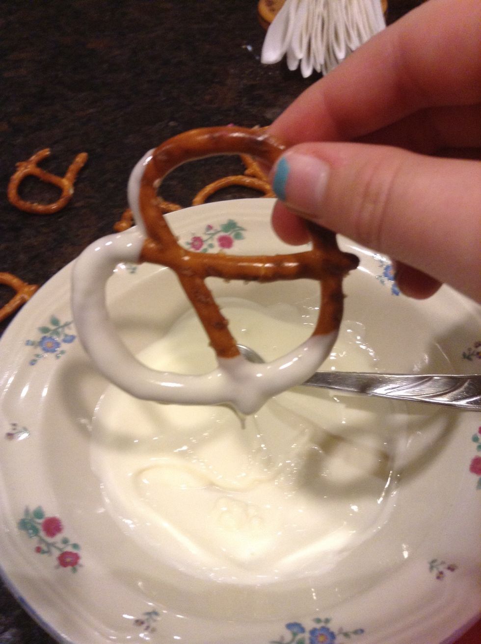 Next dip each pretzel about halfway and let it drip for a few seconds
