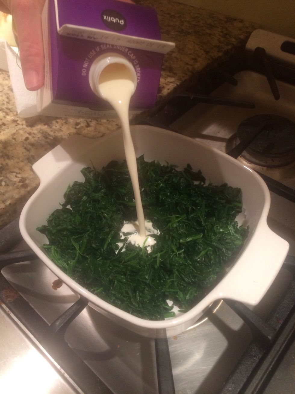 Next dish. Spinach Maria. Place the spinach in a baking pan and add whipping cream to cover the bottom