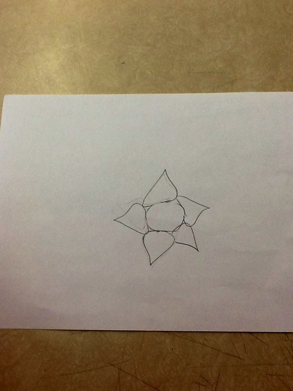 Next, draw 5 raindrop shapes around the circle.