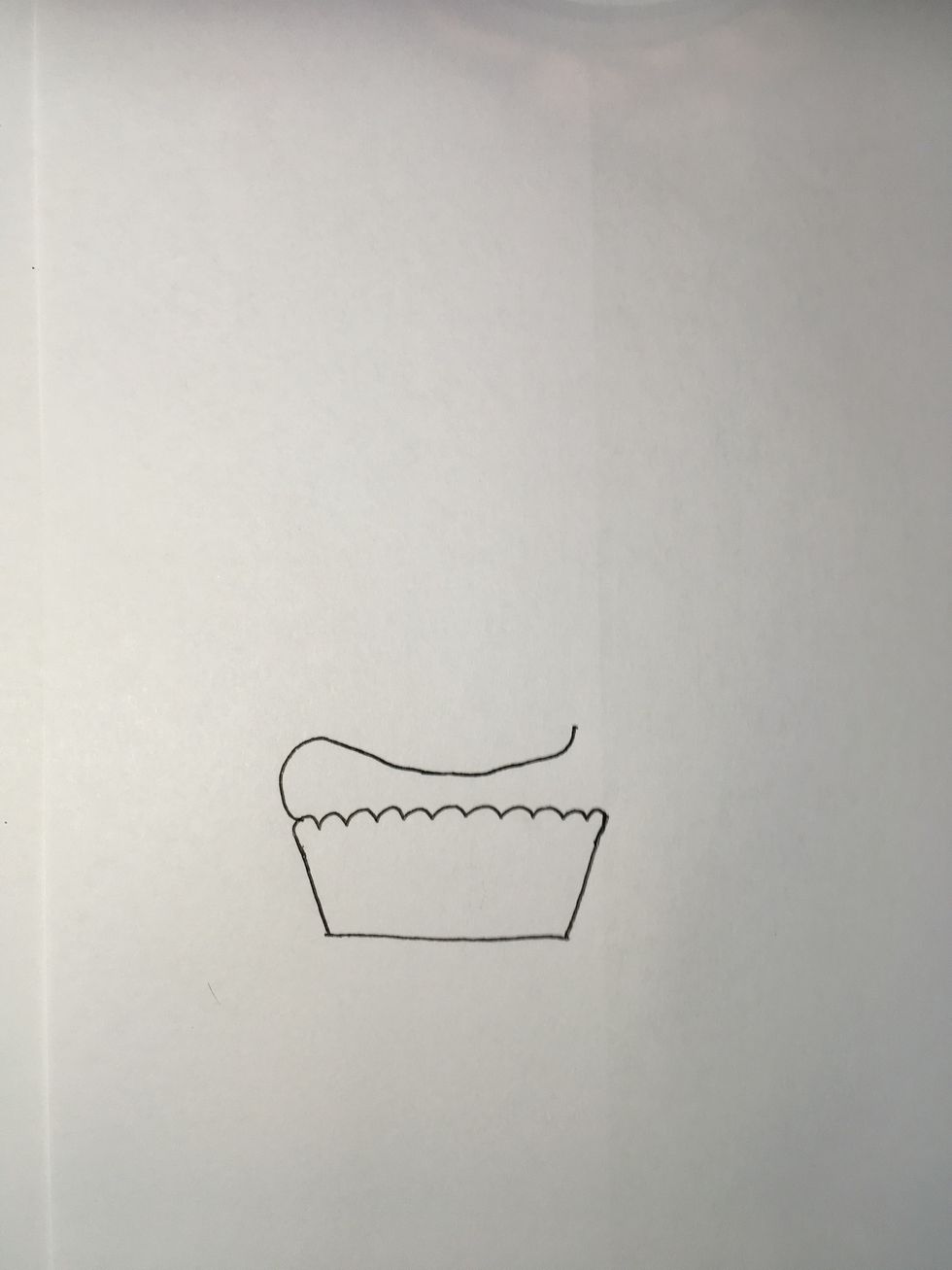Next draw a curved line on top of the cupcake liner.