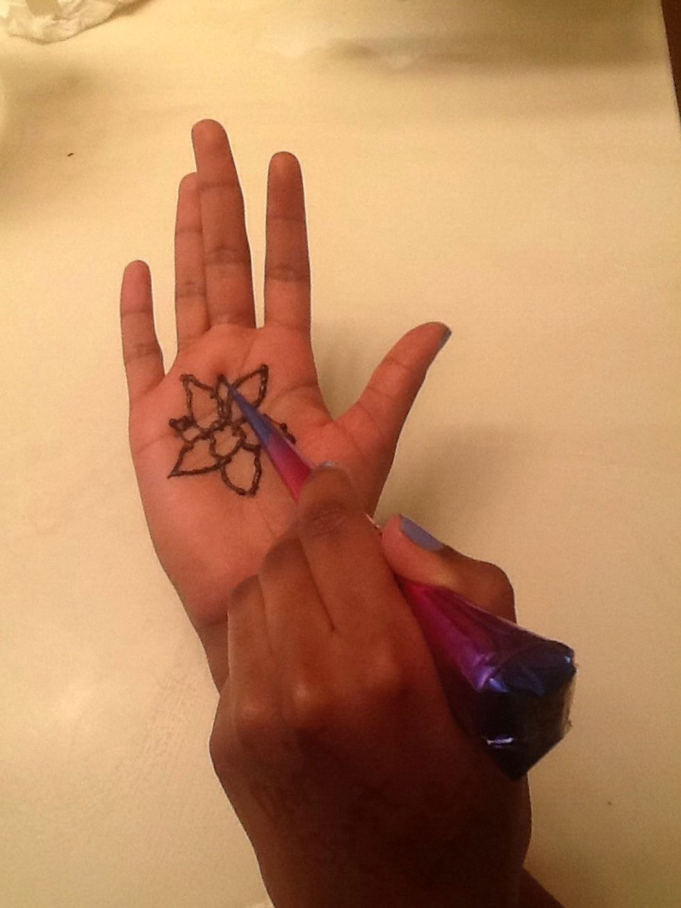 Next, draw slightly smaller petals between the petals you drew in the step before.