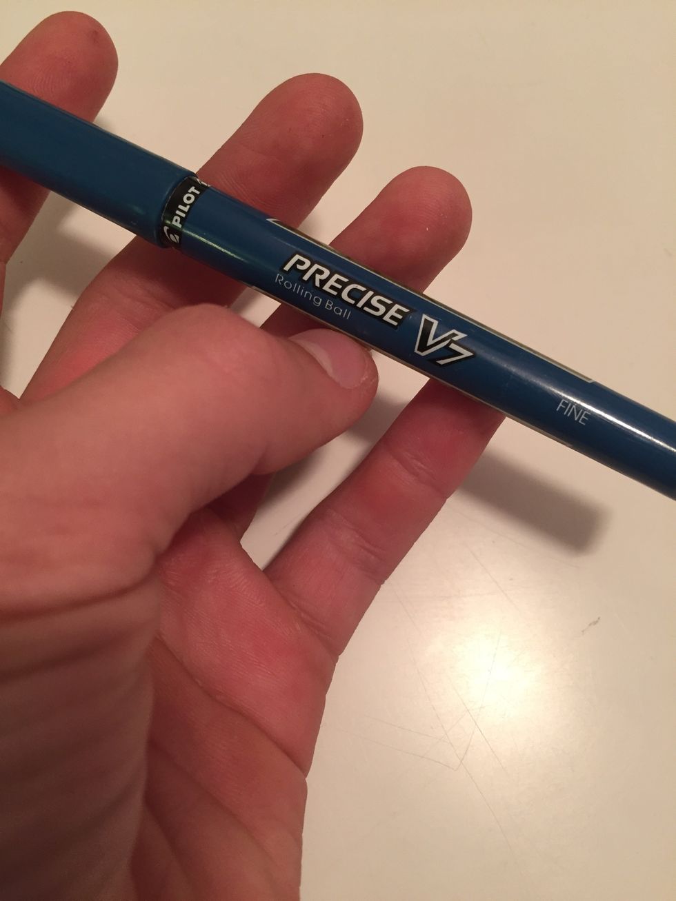 Next, find a fine-tip blue or black pen. For best results, try using a Pilot Precise v7 Fine Rolling Ball pen. Almost any blue or black pen will work, as long as it has liquid ink, but try the Pilot.