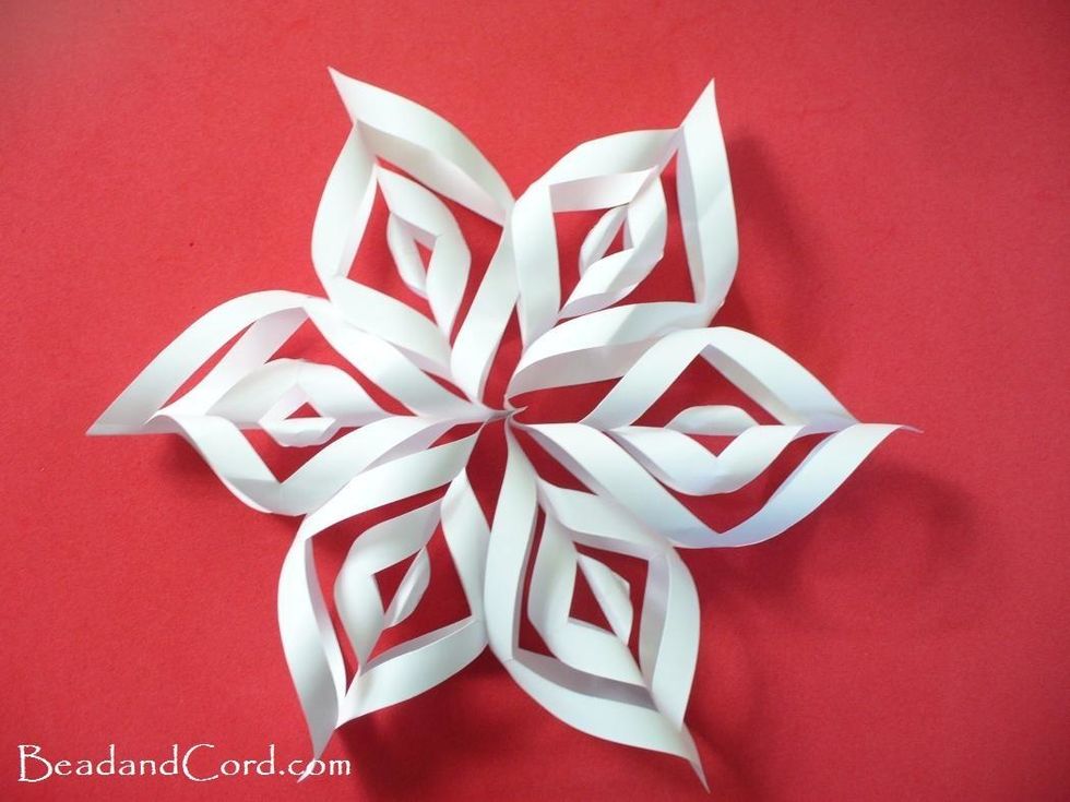 Next, flip the paper over and fold up the second centre piece and glue them to gather at the top. Do the same thing for the forth square from the middle.