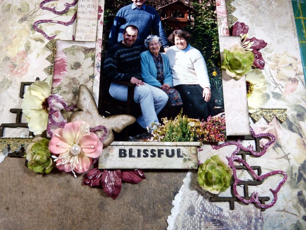 Next Flowers! Add flowers under the photo mat to add depth. Two of the flowers I cut in half and slotted them under papers, this makes flowers go further! This is the bottom clusters.....