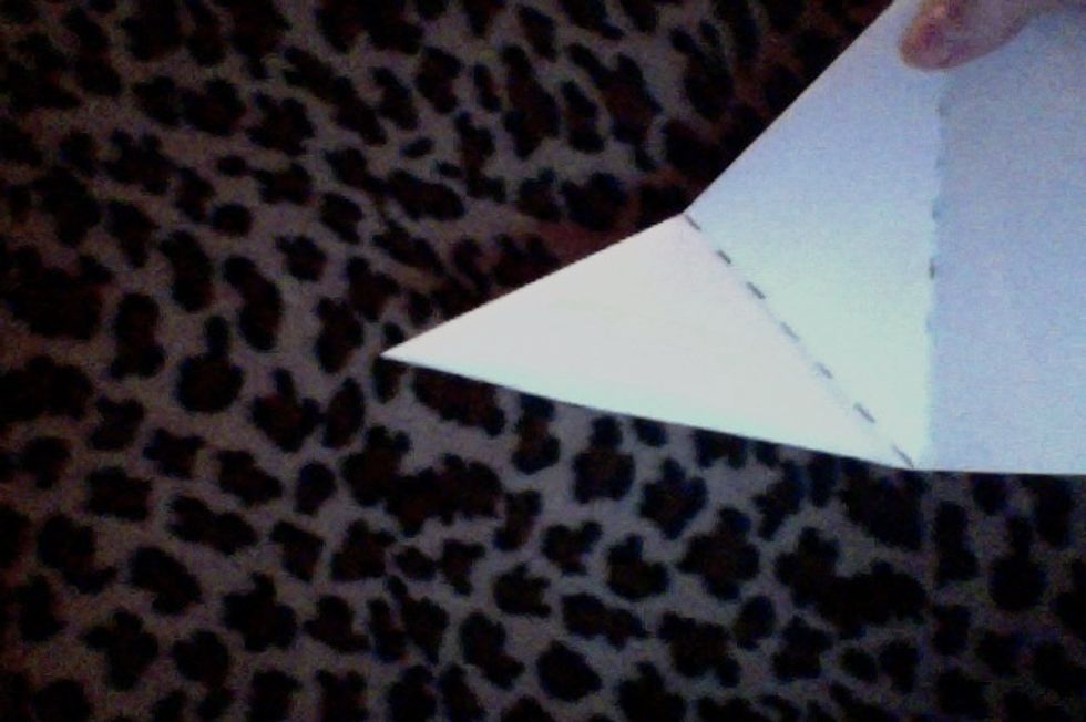 Next, fold the other corner to align with the one that has already been folded.