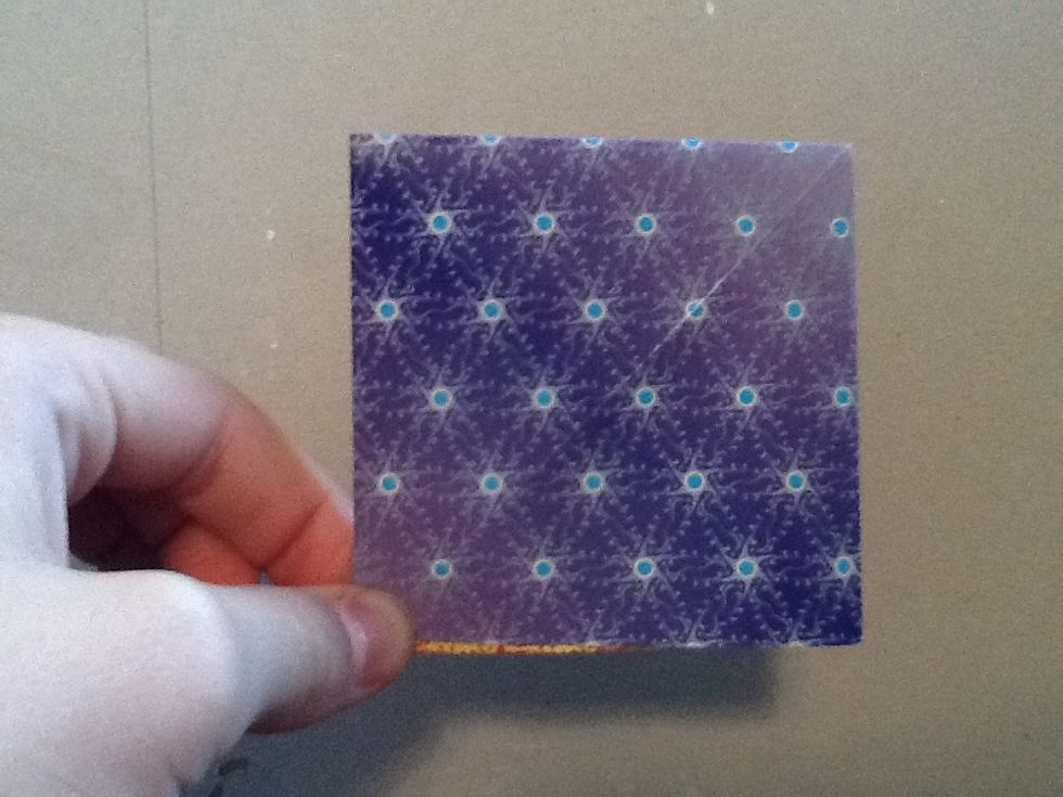 Next fold the other triangle in half to create a square on both sides.