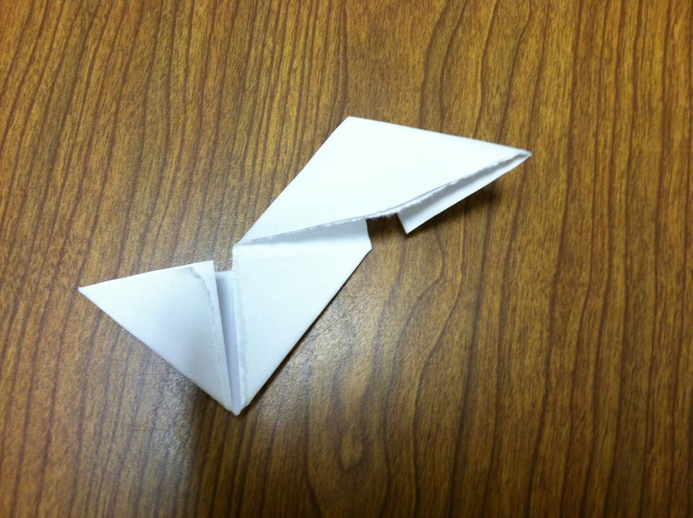 Next, fold the paper in half, tear it on the crease, then fold the paper and tear again