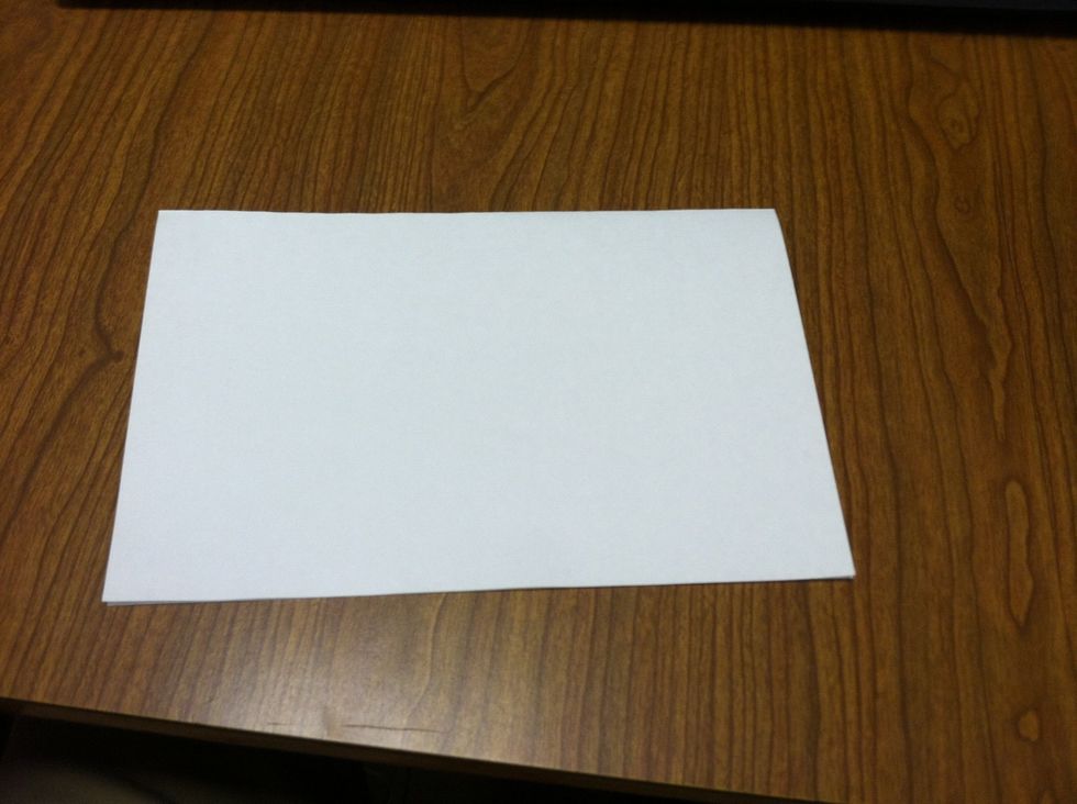 Next, fold the paper in half.