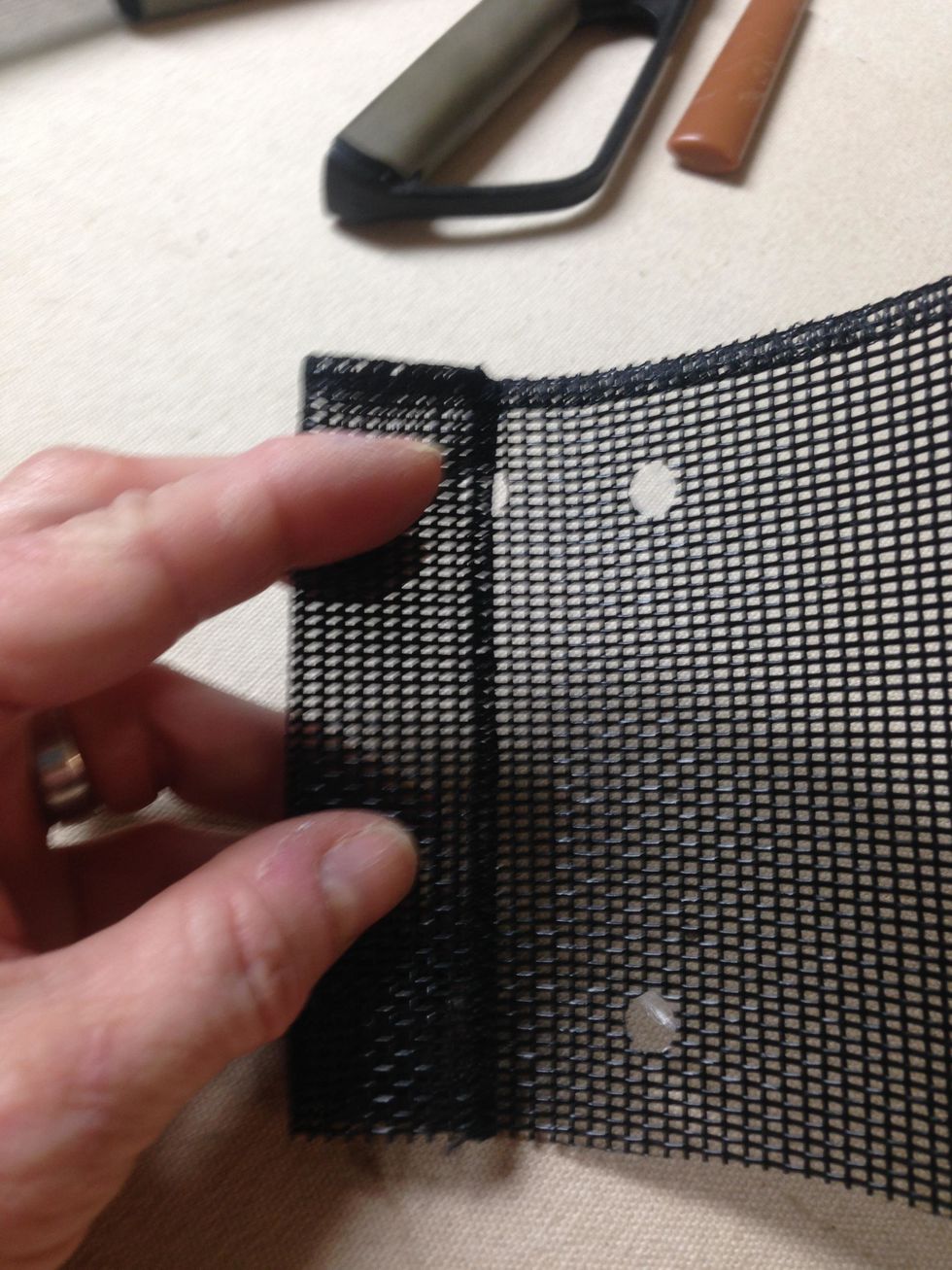 Next fold the side edge to the middle of the first two holes.  Insert into the punch and make two more holes.