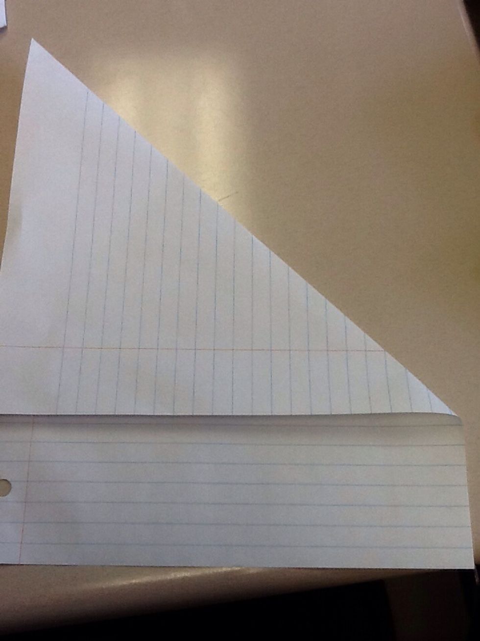Next fold the top right corner down so it meets the left side then unfold it.