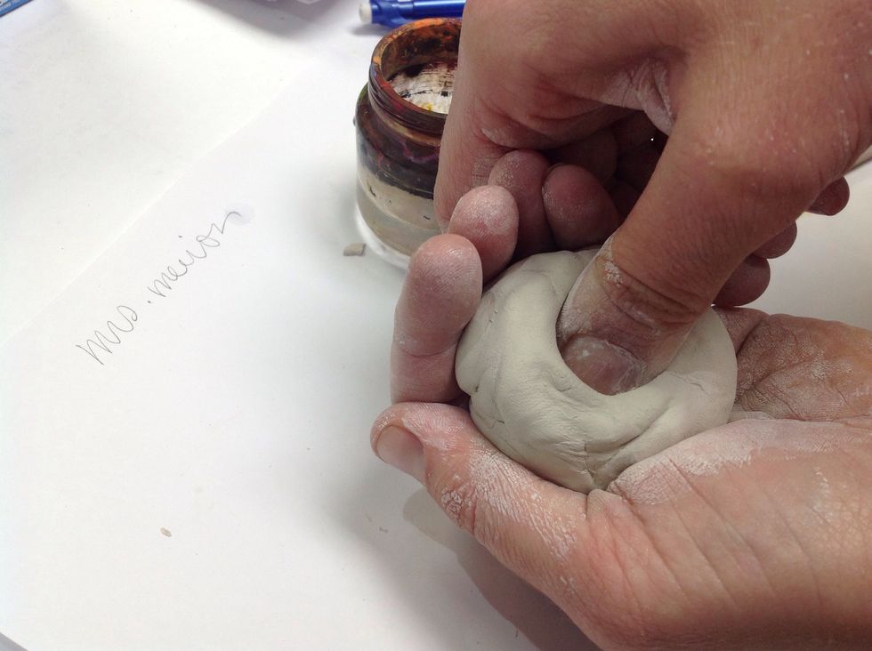Next form a pinch-pot by inserting your thumb into the ball and applying pressure against the palm of your other hand. Dampen you hands with water periodically as needed.