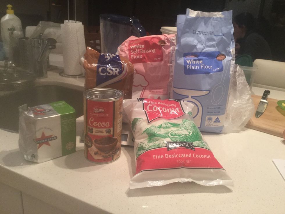 Next, gather your materials: Coconut, self raising flour, plain flour, caster sugar, butter and cocoa.