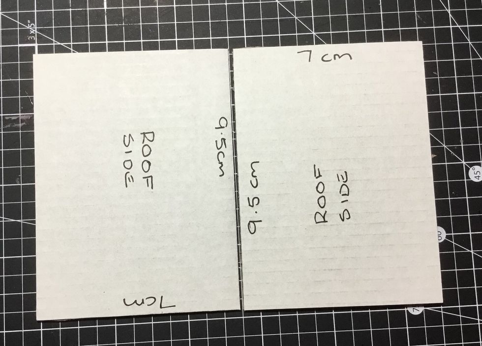 Next get 2 of the pieces cut for the roof and place as shown. Leave a small gap in between as shown and attach together using masking tape.