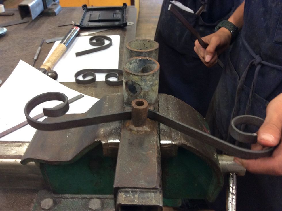 Next get one of the pieces of metal and get one of them things that bend the metal and bend the middle of the metal