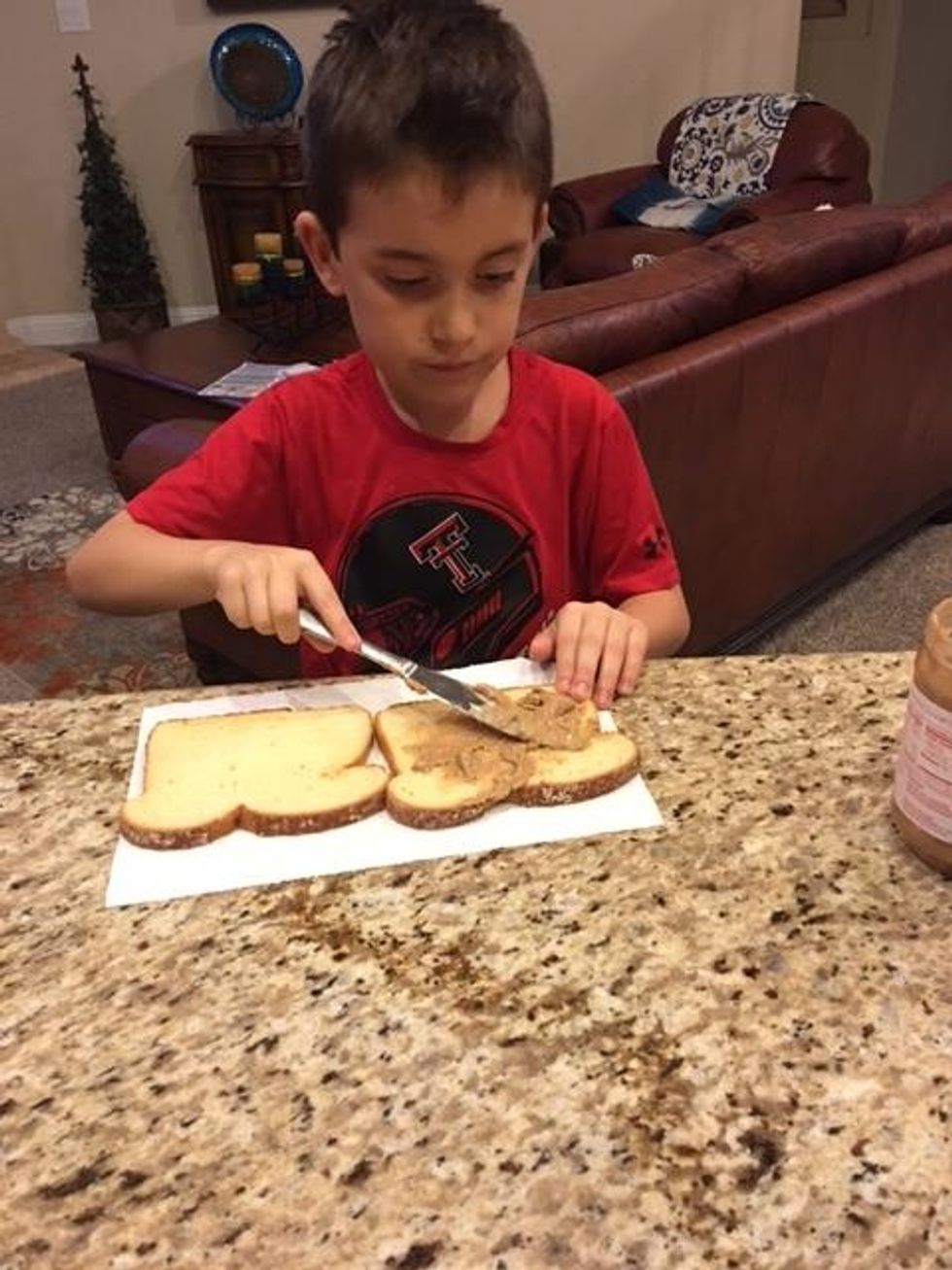 Next, get your peanut butter out and get your knife out. Then scoop up your peanut butter on your knife and spread it on your bred.