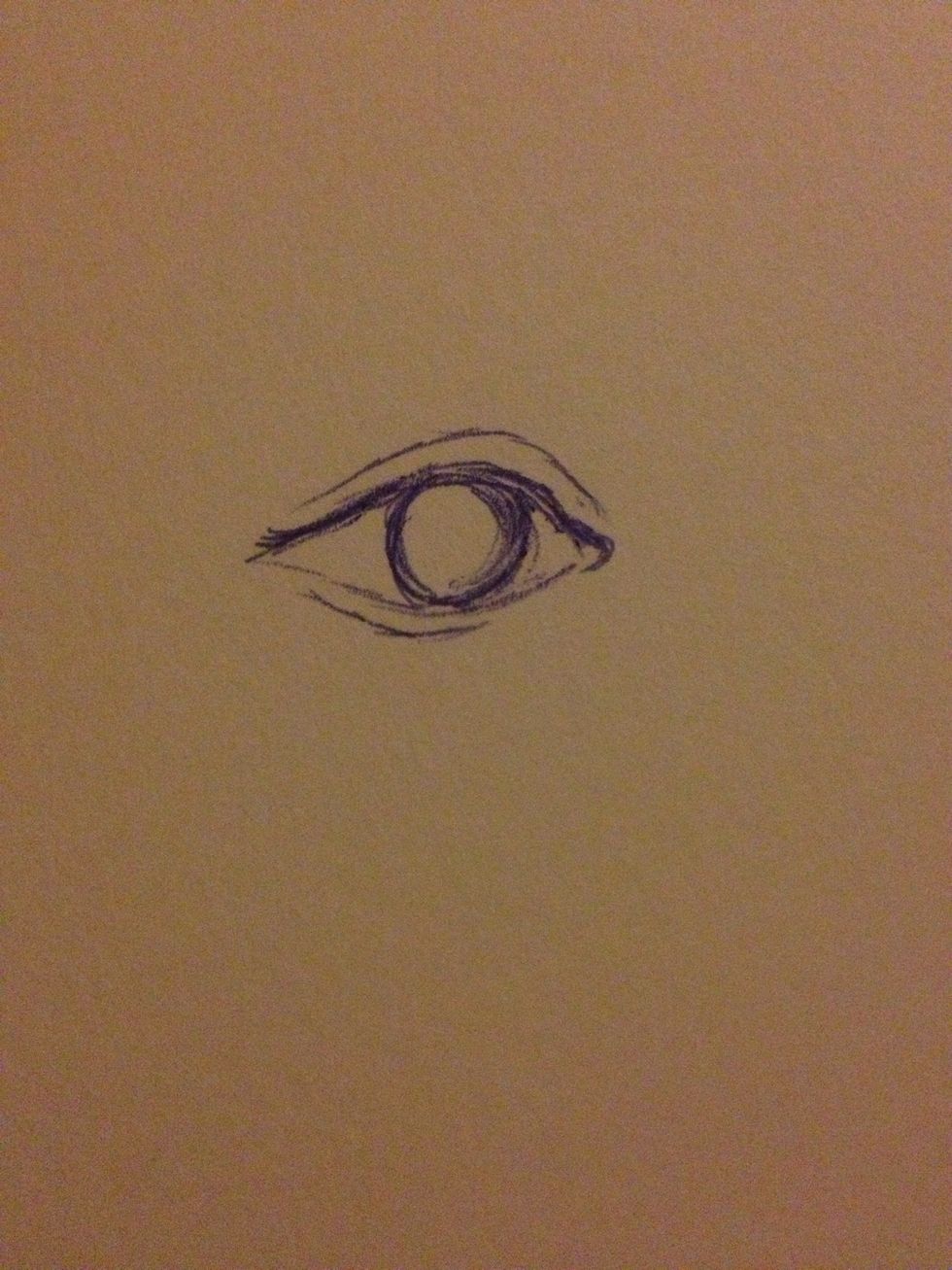Next, give your eye a bit of dimension by adding creases at the top and bottom of the eye outline. Also, draw an outline of the iris.