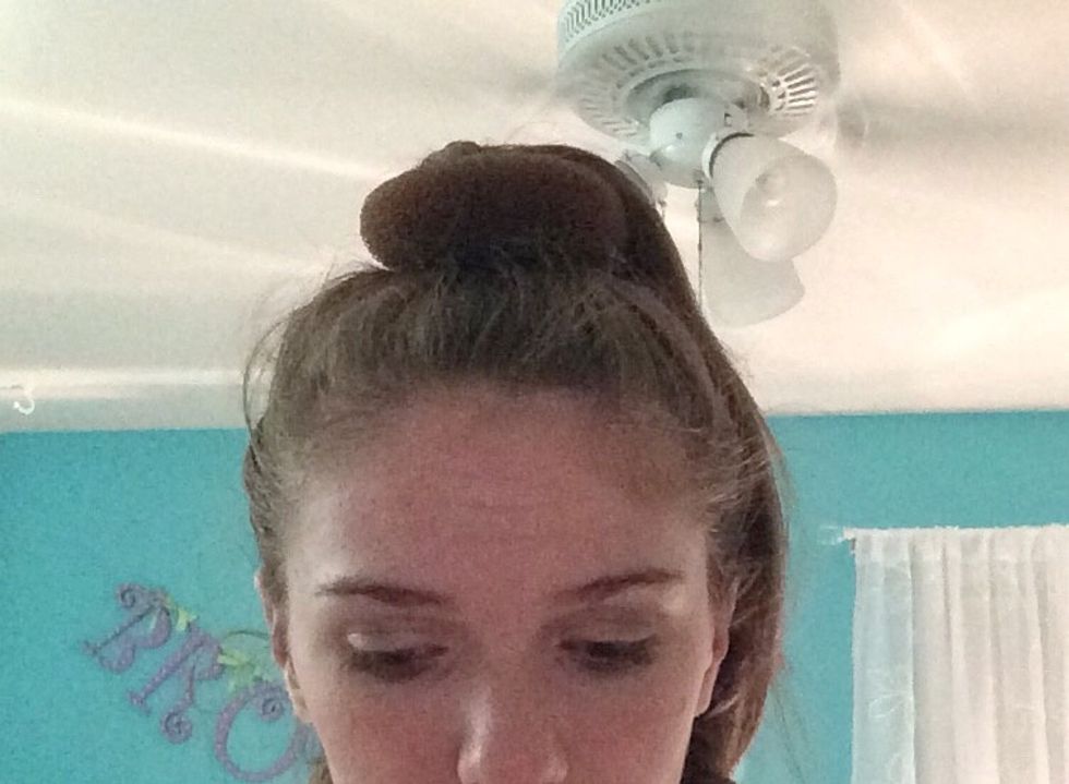 Next, grab the bun make and pull it over your pony tail.