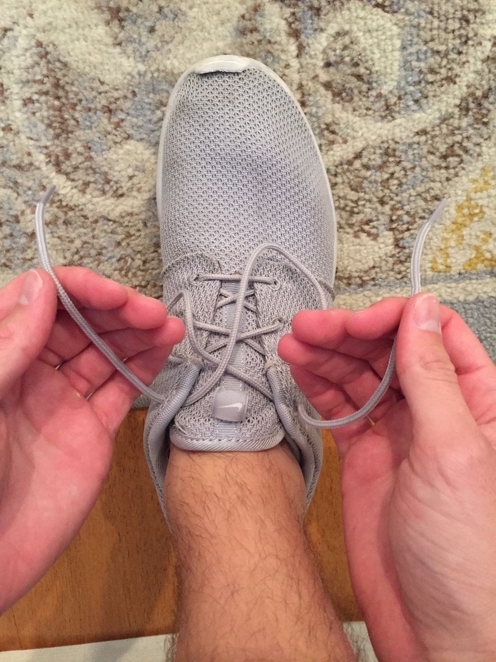 Next, grab the laces on each corresponding side