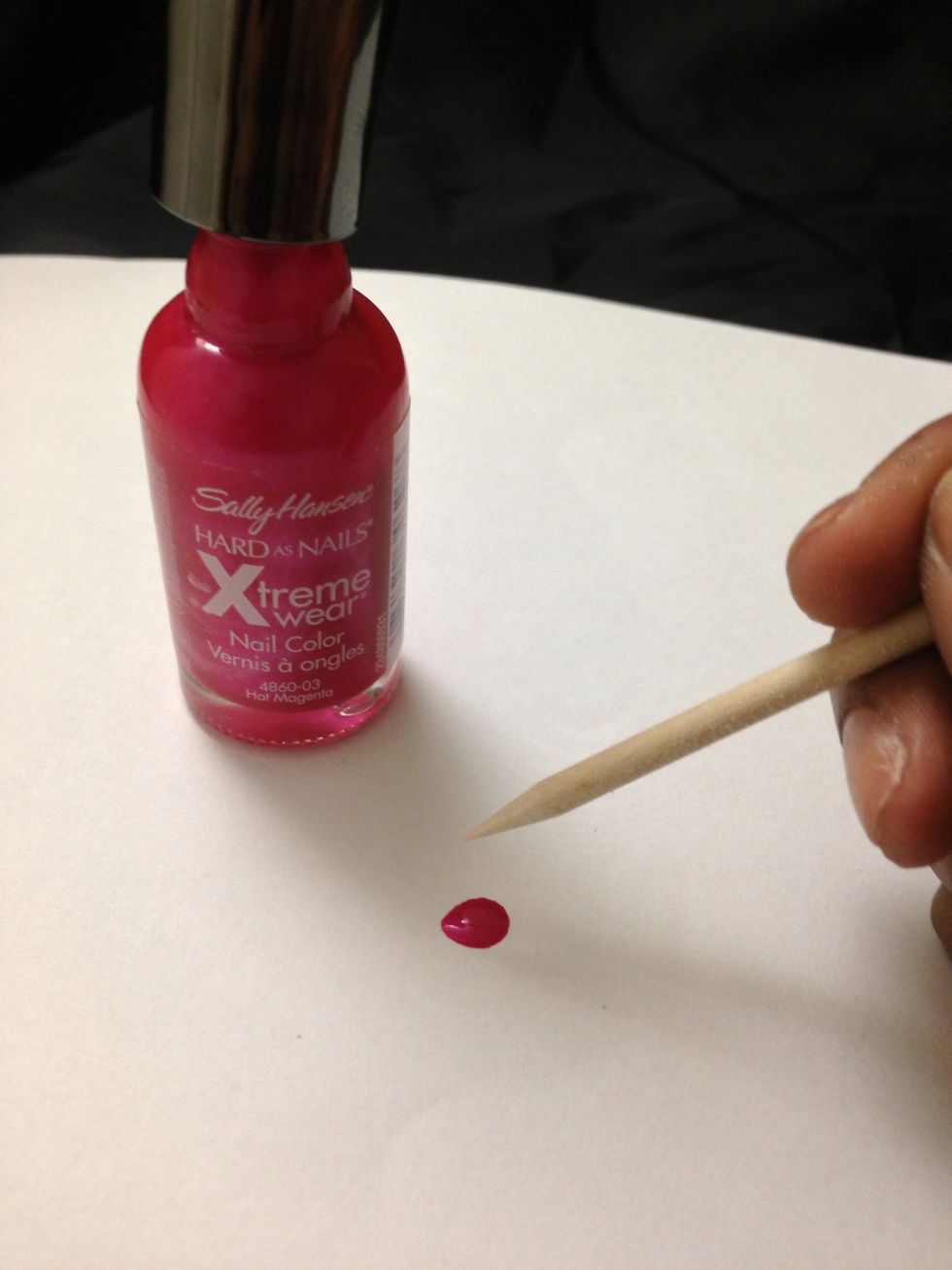 Next grab your dark pink color and your tooth pick. Drop some paint on a piece of paper and dip your toothpick to pick up some color. I'm using Hot Magenta by Sally Hansen.