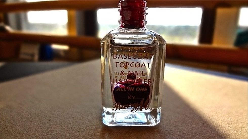 Next gradually add your chosen food colorant. Don't be fooled by how intense the colour looks, you will need a lot! For this tutorial I used 12 drops of red and 3 yellow.