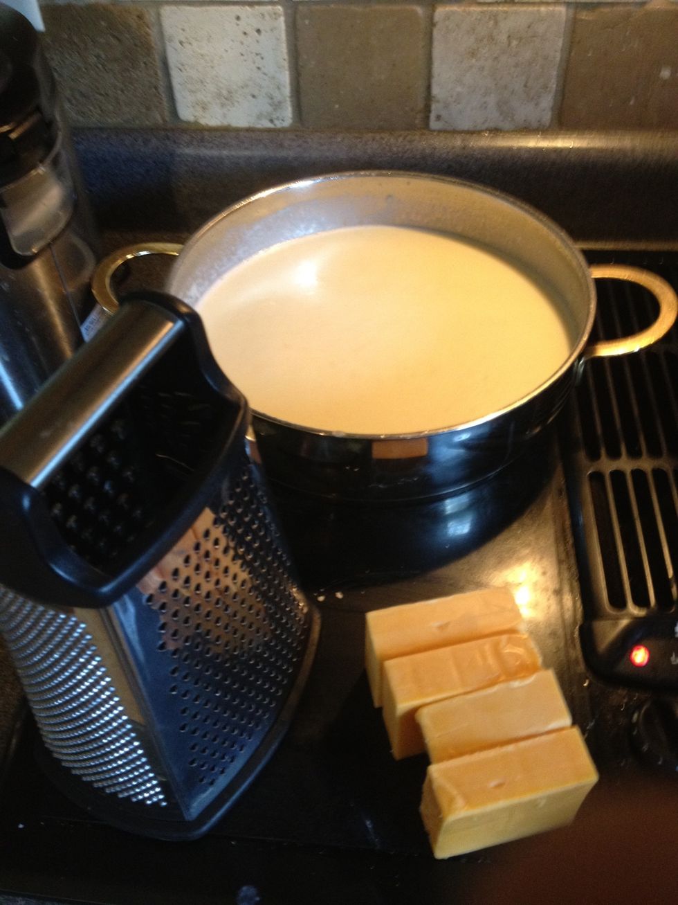 Next grate in your fresh cheese while whisking