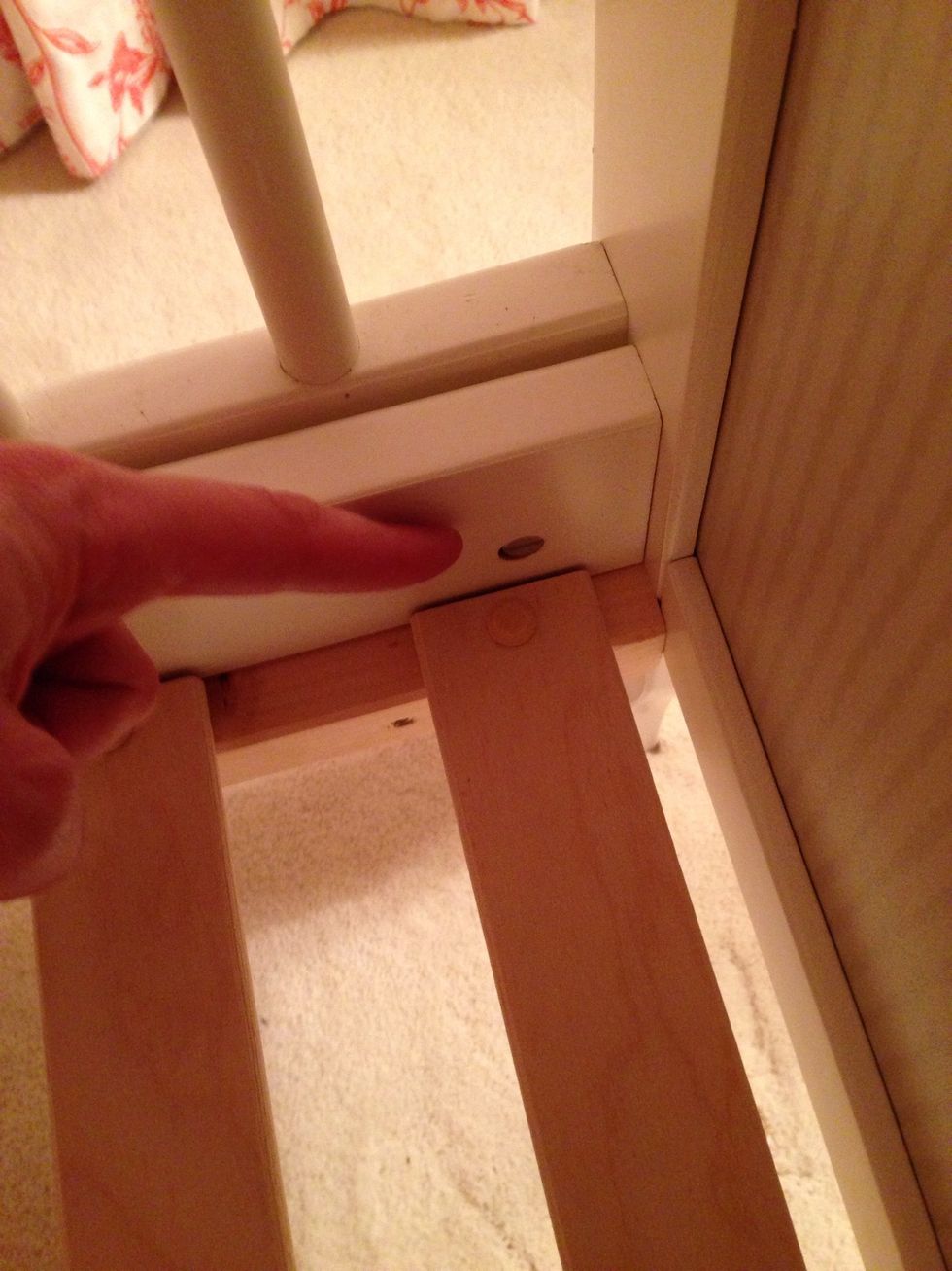 Next, have 1 person hold the bottom part up while the other person installs the screw things. Here's where the metal caps go. I suggest getting a screw in each corner first so your friend can let go.