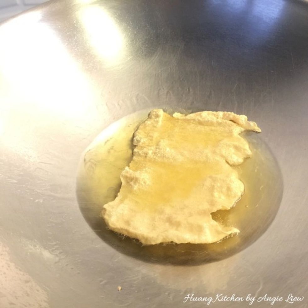 Next, heat a wok with oil over high heat. Once oil is hot enough, fry the dried beancurd skin, piece by piece, till just golden brown. Each piece takes less than a minute.