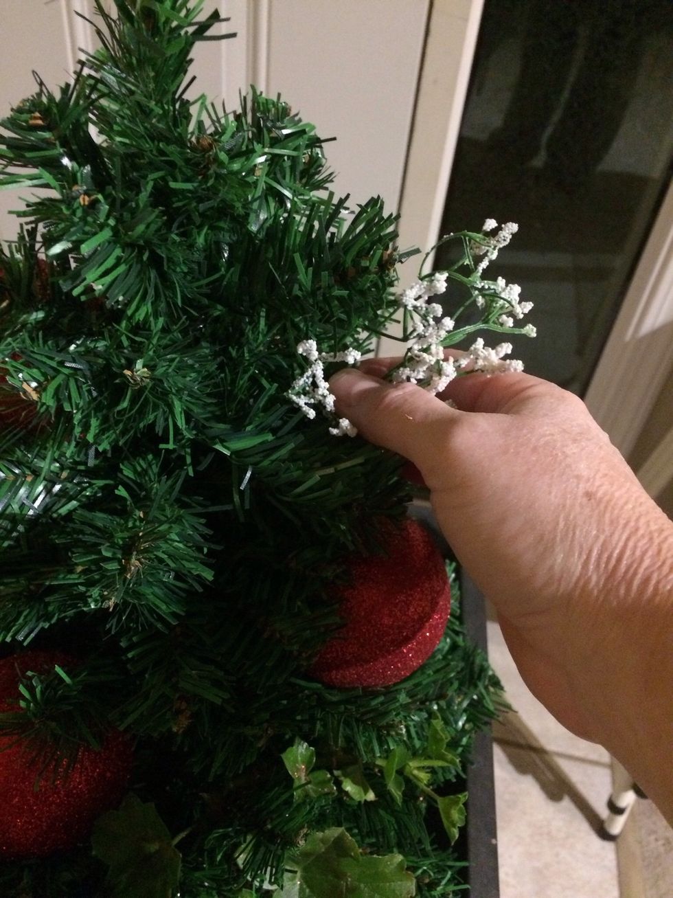 Next I added the snow tipped greenery. As a background filler it might have made more sense to add those first, but I don't think it really matters. Just slide them in stem first.