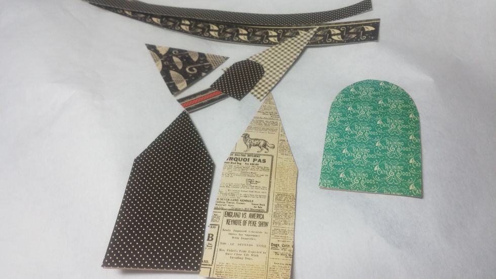 Next I cut out my house shapes with chipboard and my chosen printed paper. I free hand cut roof and door elements as well.