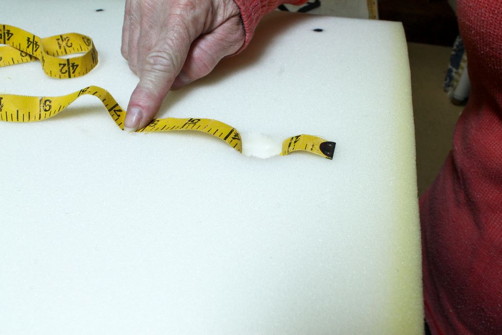 Next I determined how much to allow for each tuft. Push a cloth measuring tape all the way into the foam. I needed to allow 3" of fabric for each tuft.