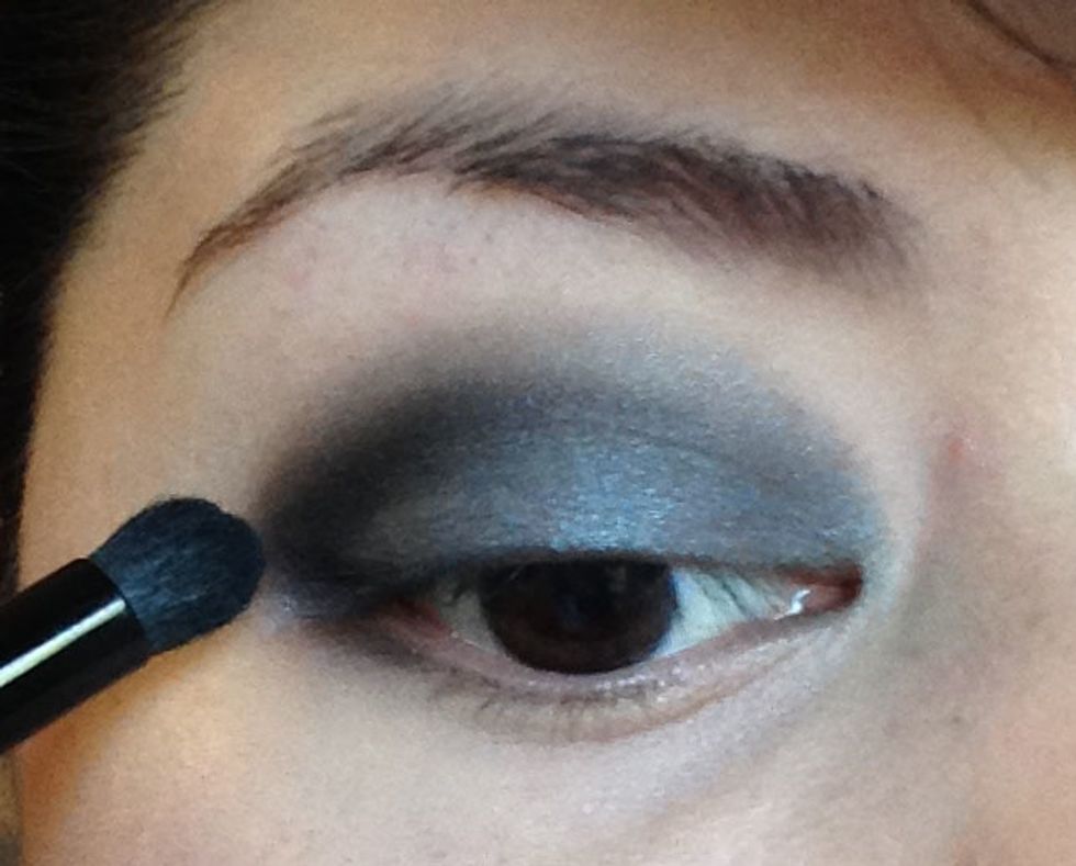 Next I have taken some of the Sapphire shade (a shimmery blue black color) and applied it just to my outer V, my outer corner of my eye and crease only.  I am using a smaller brush to apply it.