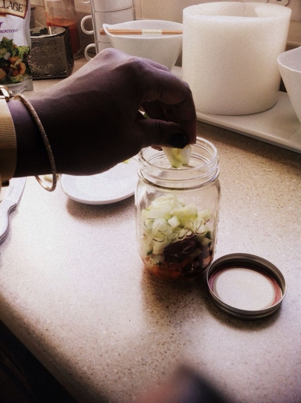 Next I layer in my "not so hard veggies" like cucumbers. You could also add beans or corn at this layer.