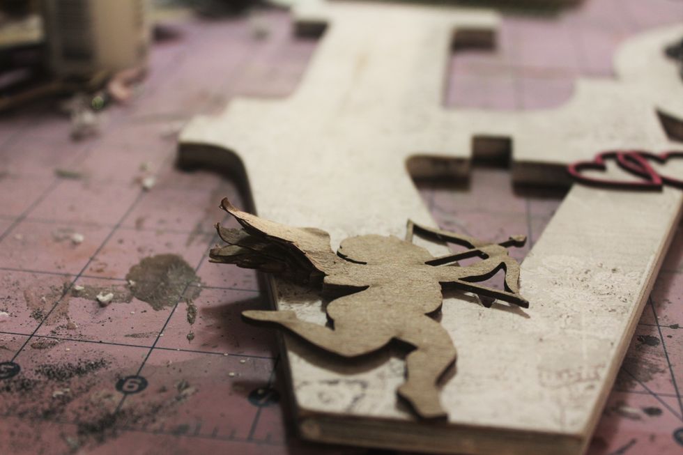 Next, I let the chipboard angel soak in warm water for about 5 minutes. Then, I pulled apart the layers of her wings so she looked like this. I used my embossing gun to dry her at this point.