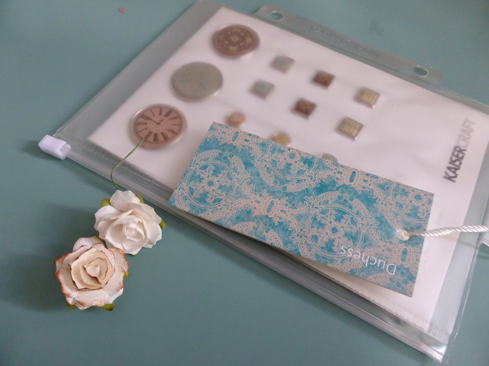 Next I'm using the Kaisercraft Duchess Brads, along with the tag on the brad packet. Also I have some white flowers from my stash which I added brown distress ink to the edges