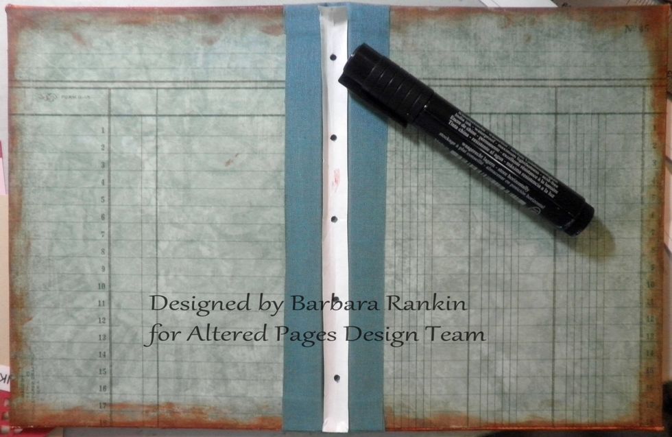 Next, I trimmed off the excess paper from my template to fit inside the spine, and used a hole punch to punch through the pencil marks. This allowed me to mark my spine with a black pen.