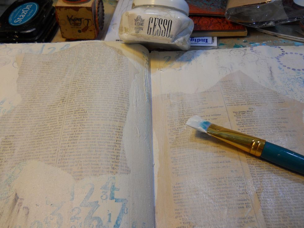 Next, I used Gesso to adhere some book pages. then do a dry brush technique over the paper. Dry brushing means to get paint on your brush, then wipe most of it off, applying whats left onto the paper.