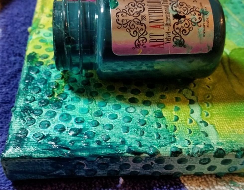 Next I worked a bit of Velvet into the background to further deepen the color. Also I worked the pain around the edge of the canvas to color the sides.