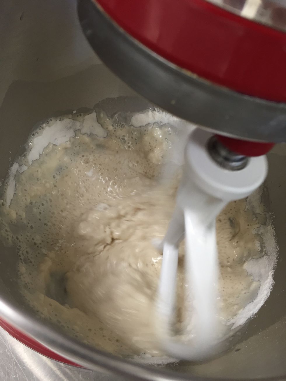 Next, in your electric mixer, stir in the one tablespoon of sugar, two tablespoons of vegetable oil, one teaspoon of salt, and only one cup of flour.