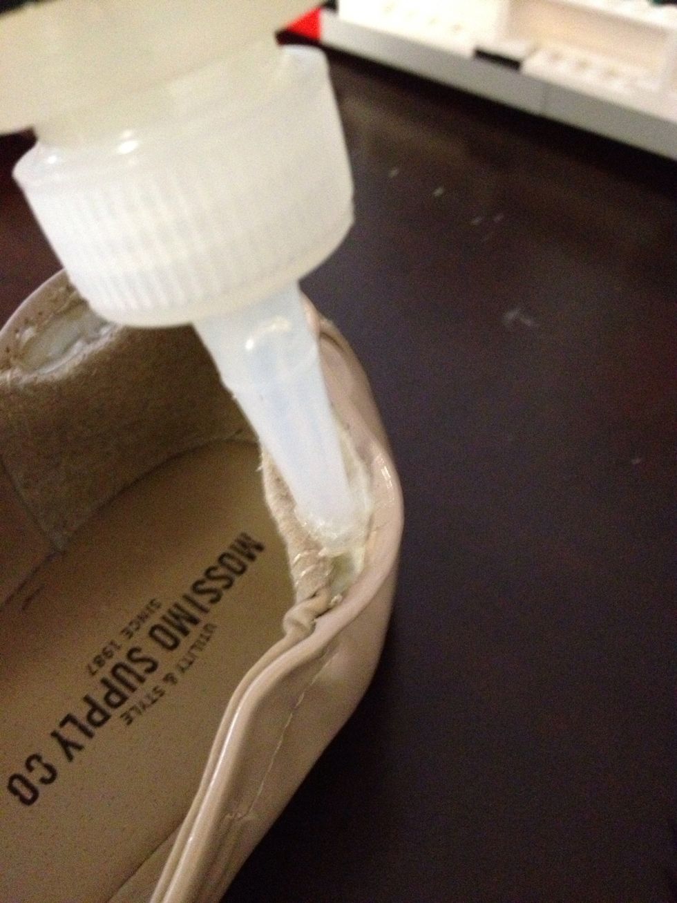 Next, insert the tip of the glue bottle into the slit, and squeeze a LITTLE bit of glue in. You can always add more, but a good adhesive is a pain to clean if you use too much! Spread the glue evenly