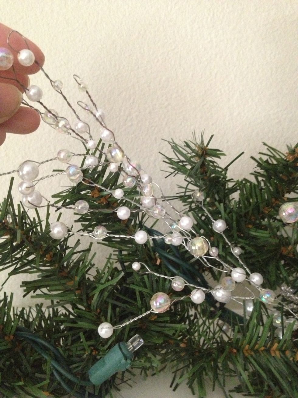 Next, interlace your jeweled/beaded garland through the green garland. You could use, twine, burlap ribbon, glitter ribbon, etc to make the look more rustic, modern, etc.