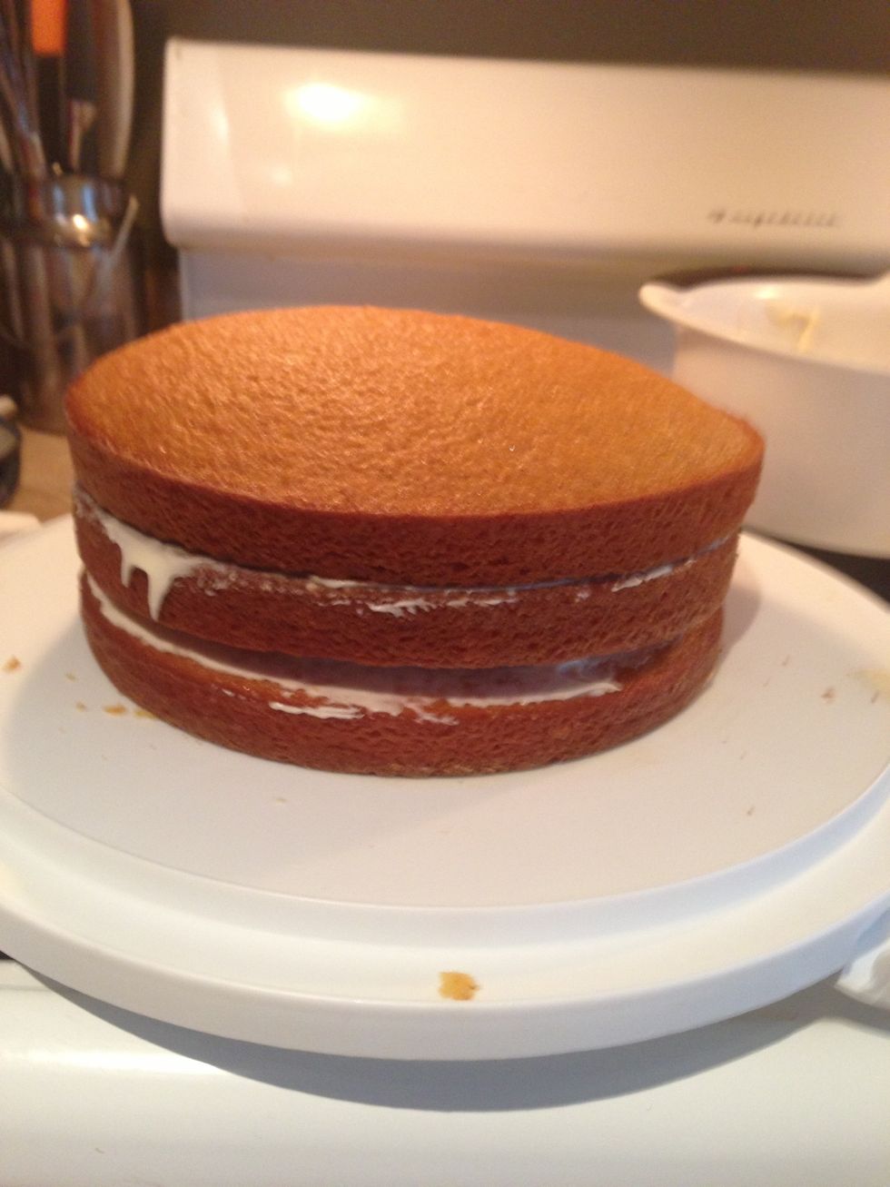 Next is to top the layers of frosted cakes with the top layer right side up.