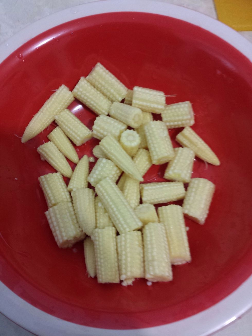 Next, just wash the baby corn and cut them in half. Then put it in a bowl.